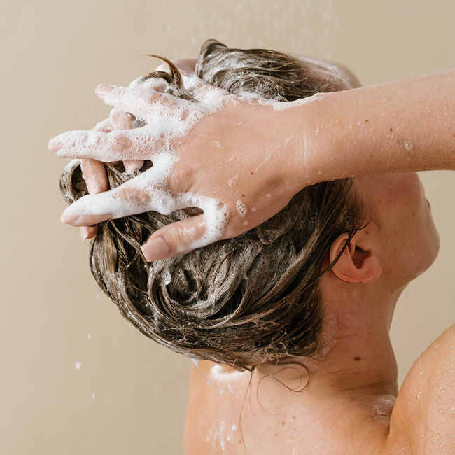 cropped photo of someone shampooing their hair